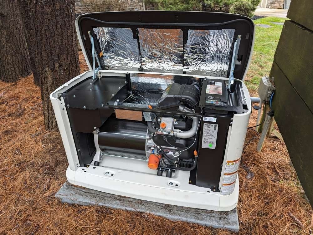 Internal engine and component view of a newly installed Generac standby generator in an Elkhart County yard.